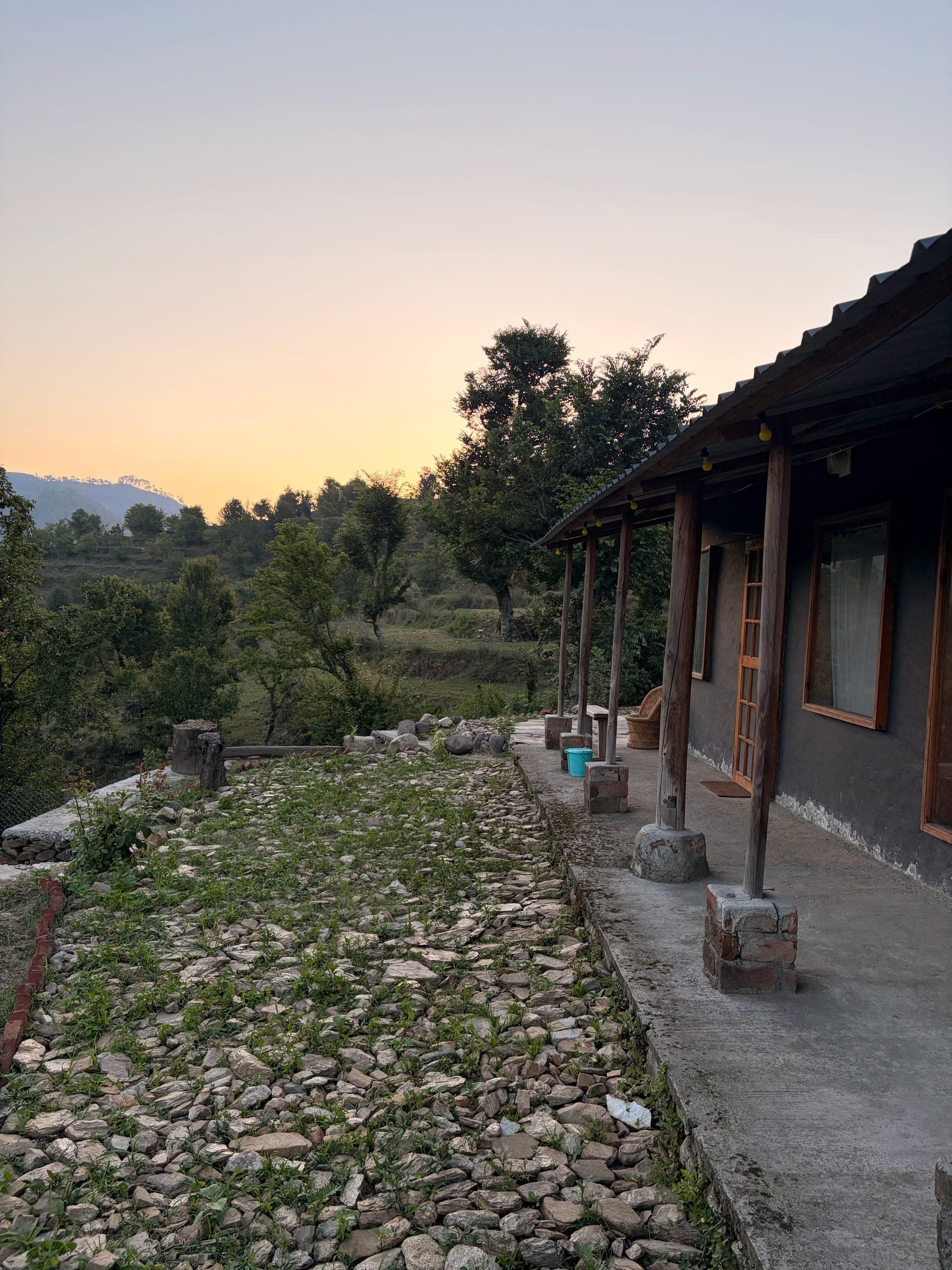 Veranda of The Vintage Kumaon at sunset, looking over the hills